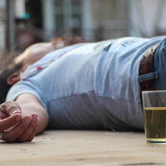 Man passed out by alcoholic drink